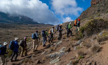 people hiking on mountain during daytime