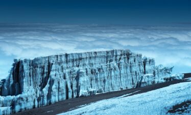 gray rocky mountain under cloudy sky during daytime