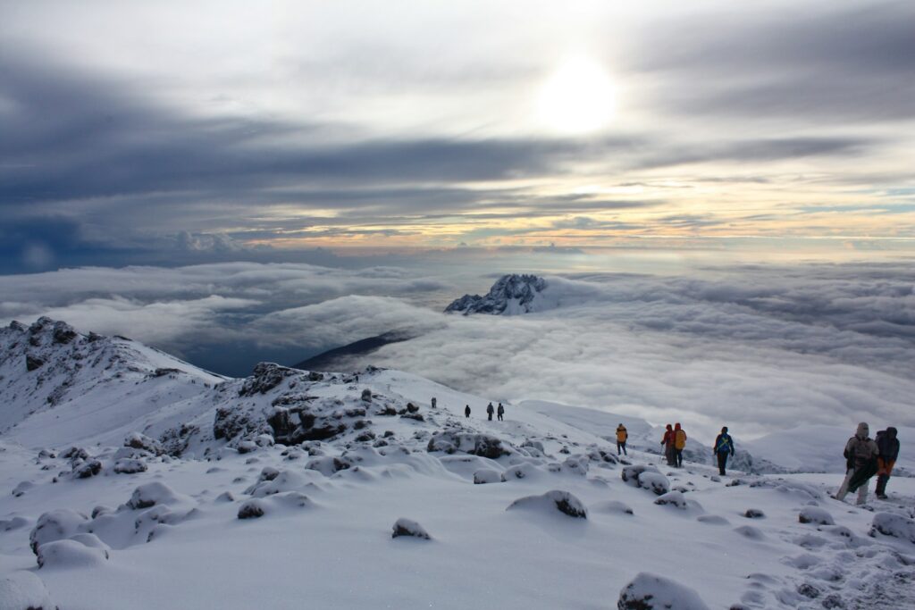 people on snow covered mountain during daytime